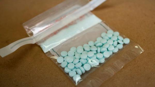 Tablets believed to be laced with fentanyl are displayed at a Drug Enforcement Administration lab in New York in 2019. The Biden administration is hoping to crack down on abuse of synthetic opioids in part by putting them in the most restricted category or "schedule" under the law.