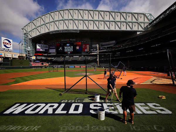 The grounds crew prepares the field during a workout prior to the start of the World Series between the Houston Astros and the Atlanta Braves at Minute Maid Park on Monday in Houston.
