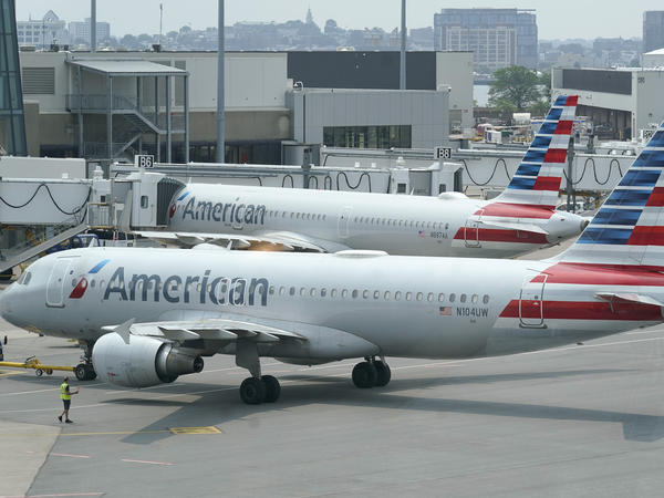 American Airlines passenger jets prepare for departure near a terminal at Boston Logan International Airport in Boston in July. More than 1,000 flights were canceled this weekend due to weather and staffing shortages, the airline said.