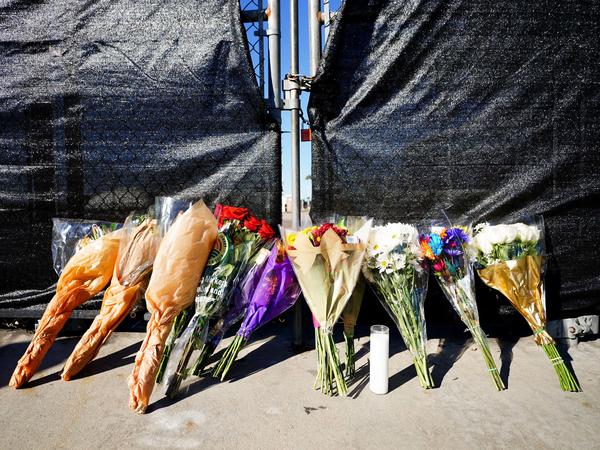 Flowers rest outside of the canceled Astroworld festival at NRG Park in Houston on Saturday. The crowd surge that killed eight people calls to mind other concerts and music festivals that turned deadly in recent decades.