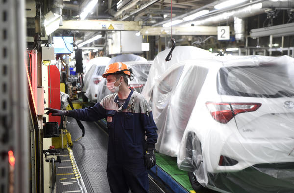 An employee of Toyota company works on an assembly line on April 21, 2020 in Onnaing, northern France.