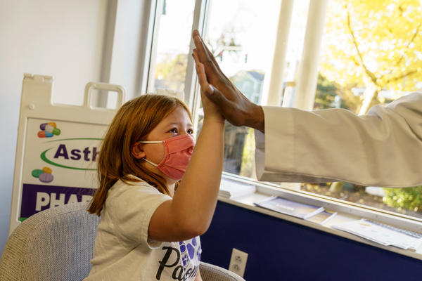Hannah Beltram, 6, high-fives Dr. Eugenio Fernandez after she received the Pfizer COVID-19 vaccine for children ages 5-11 at Asthenis Pharmacy in Providence, R.I., Friday, Nov. 5, 2021.