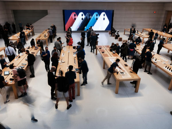 People shop at the Fifth Avenue Apple Store in September in New York City. Apple says customers who want to repair their own devices will be able to buy the parts and tools to do so for certain products starting early next year.