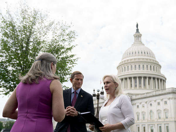 Sen. Kirsten Gillibrand, D-N.Y., (right), speaks to Sen. Richard Blumenthal, D-Conn., and Sen. Joni Ernst, R-Iowa, following an April 29 news conference on the Military Justice Improvement and Increasing Prevention Act.