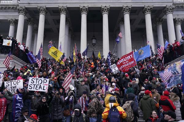 Rioters take to the steps of the U.S. Capitol on Jan. 6. An NPR analysis found more Capitol riot defendants may have ties to the Oath Keepers, a far-right group, than was previously known.