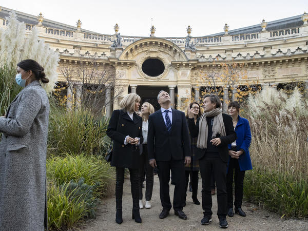 Second gentleman Douglas Emhoff looks up as he tours an exhibition at the Petit Palais museum with French first lady Brigitte Macron and artist Jean-Michel Othoniel, right.