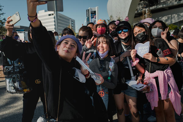 Two separate groups of fans from the Philippines take a photo together before the BTS concert at SoFi Stadium in Inglewood, Calif., on Nov. 27.