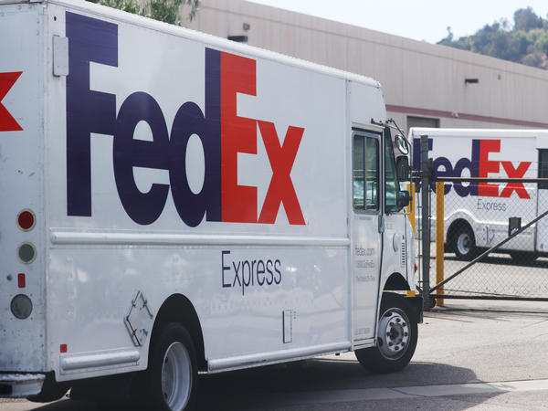 FedEx trucks are parked at a FedEx Ship Center on September 22, 2021 in Los Angeles, California. FedEx says the driver who dumped packages into an Alabama ravine at least six times is no longer with the company.