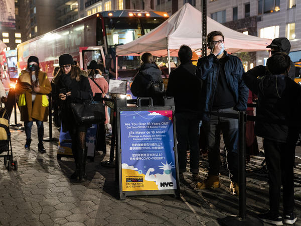 Patients wait to receive a COVID-19 vaccine booster shot at a mobile vaccination station on 59th Street below Central Park, Thursday, Dec. 2, 2021, in New York. Health officials say multiple cases of the omicron coronavirus variant have been detected in New York.
