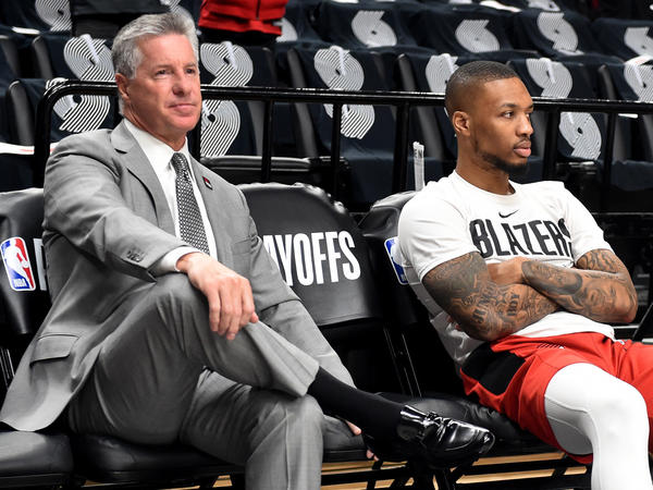 The Portland Trail Blazers fired Neil Olshey on Friday, after workers reportedly accused him of creating a hostile work environment. He's seen here sitting near Damian Lillard in 2019.