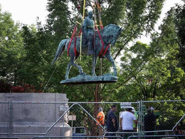 Workers remove a statue of Confederate Gen. Robert E. Lee in Charlottesville, Va., in July. Initial plans to remove the statue four years ago sparked the infamous Unite the Right rally where 32-year-old Heather Heyer was killed.