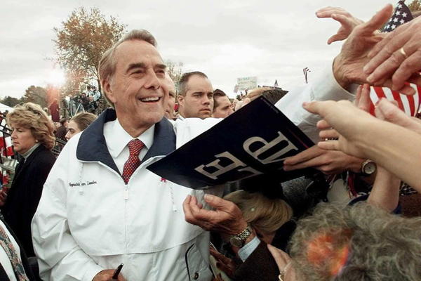 Dole shakes hands with supporters after a campaign rally in Jackson, Mich., in 1996.