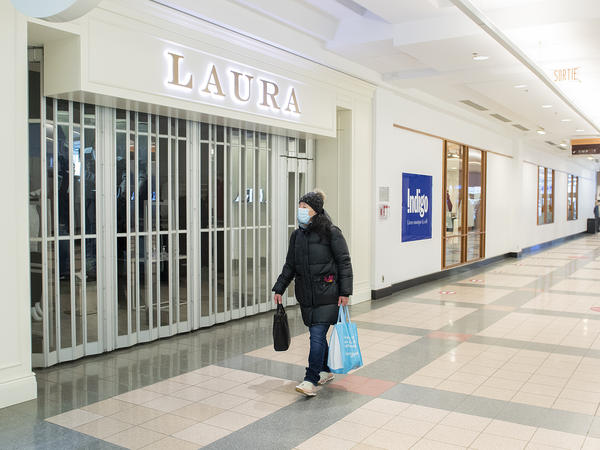 A woman walks by a closed store in a mall in Montreal on Jan. 2.