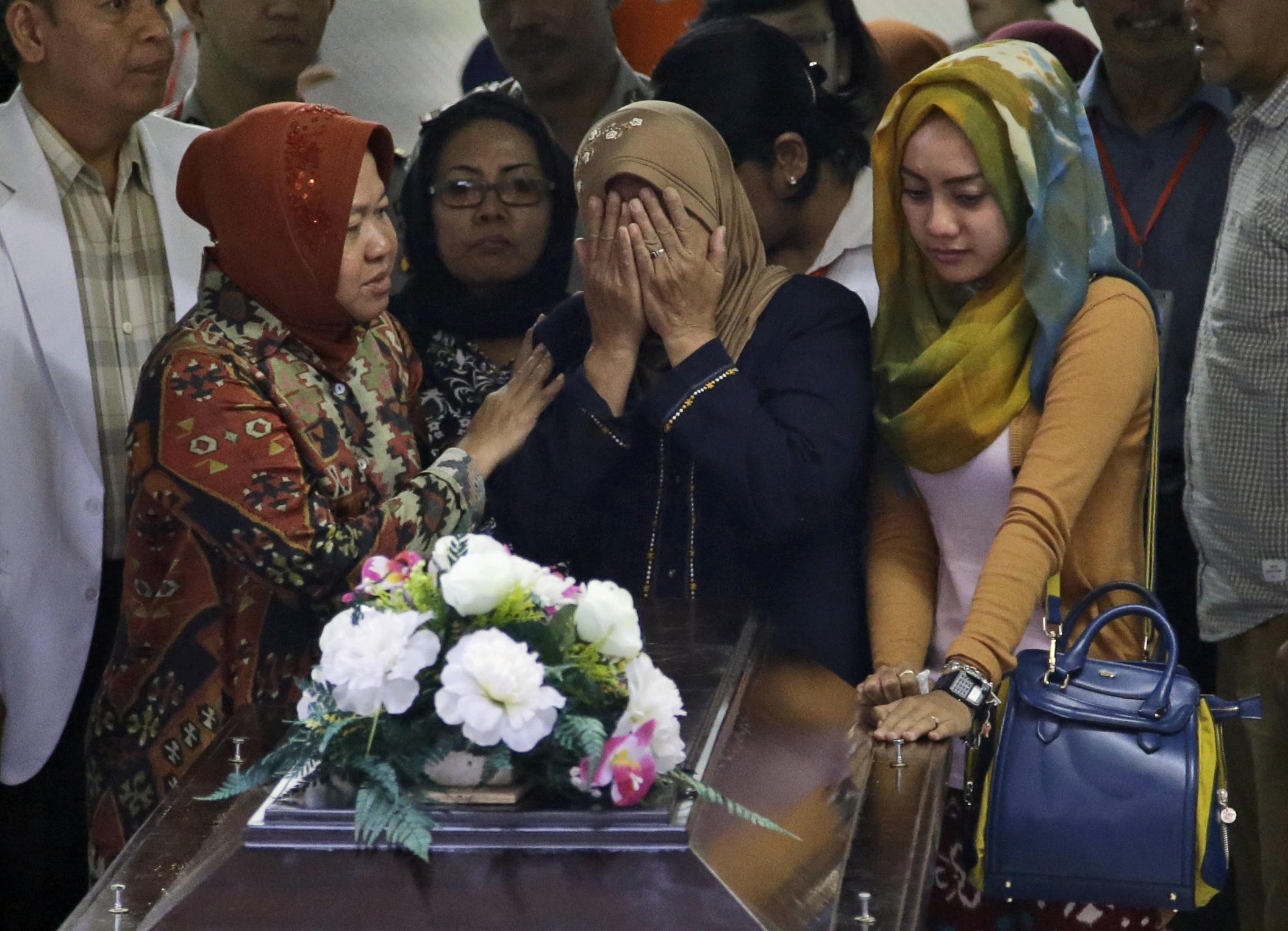 family buries first victim of airasia plane crash