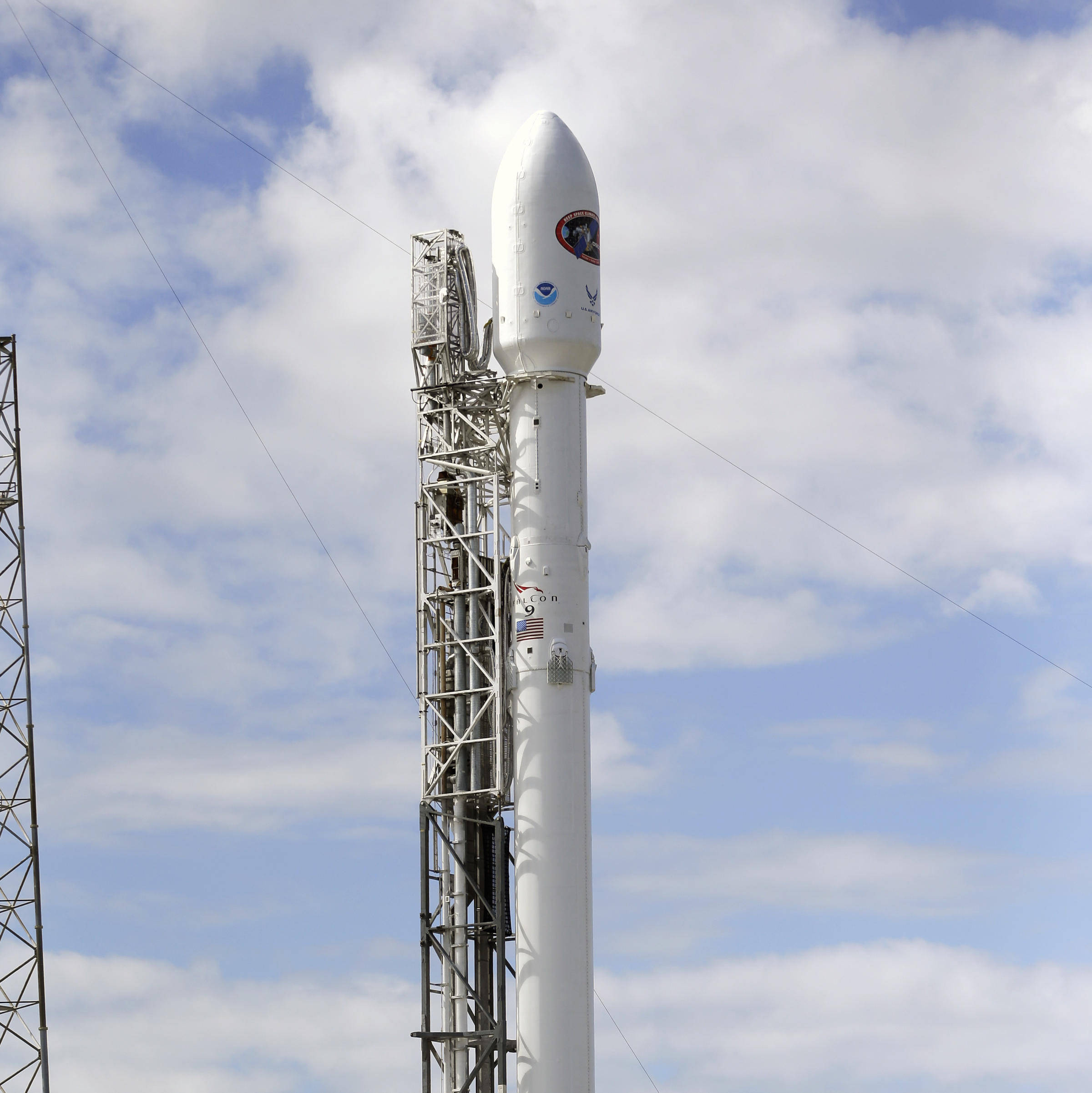 a falcon 9 spacex rocket stands ready for a sunset launch from
