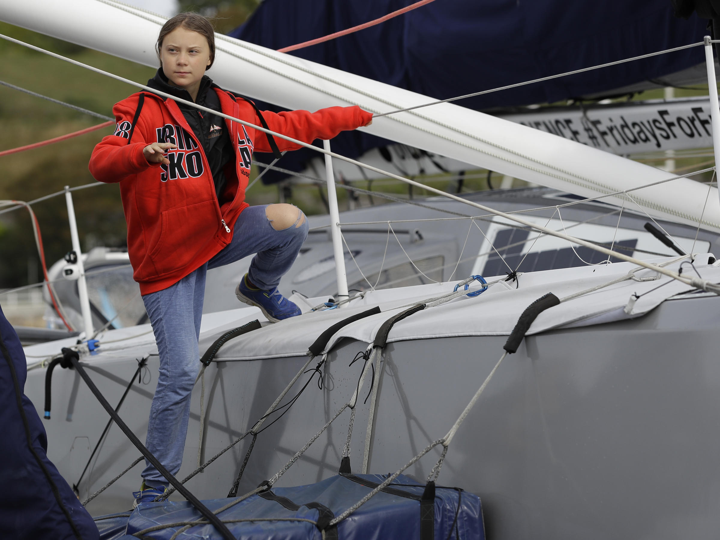 Greta Thunberg climbs onto the boat Malizia as she prepares to set off for ...