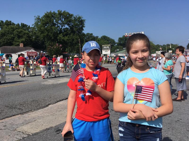 Eleven-year-old Brian Toriz and his younger sister Ailin Toriz celebrate the Fourth of July at the City of Marietta's historic downtown square on Tuesday.